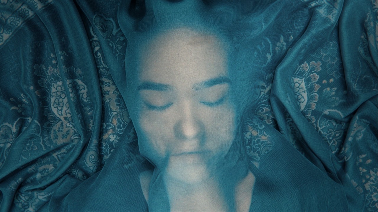 Close up of Soraya, face covered in a sheer veil